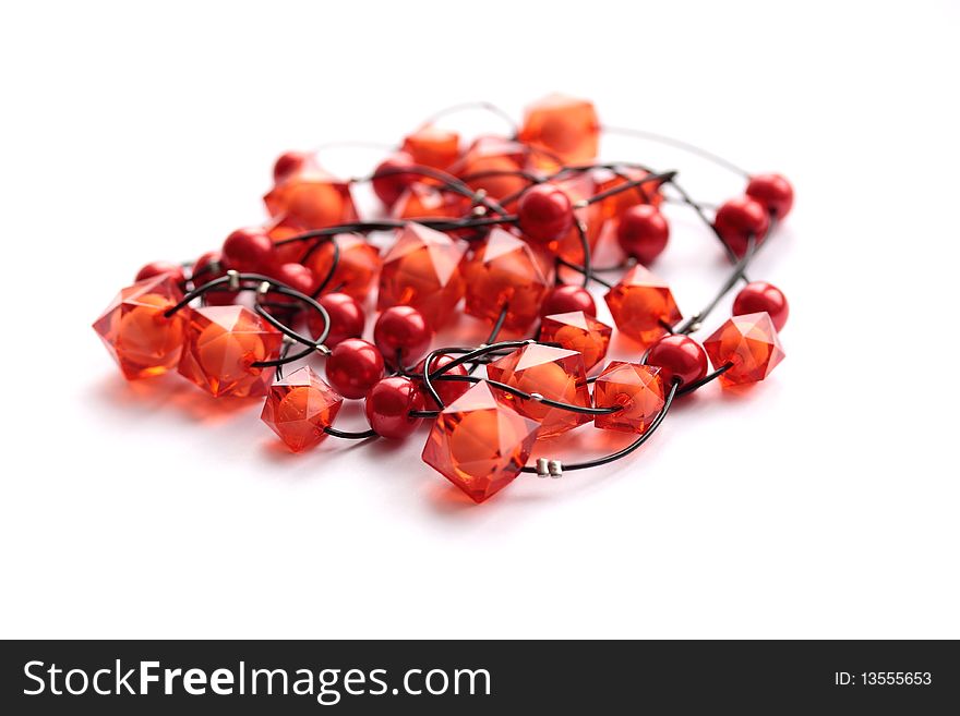 Red glass beads of the unusual form on white background. Red glass beads of the unusual form on white background