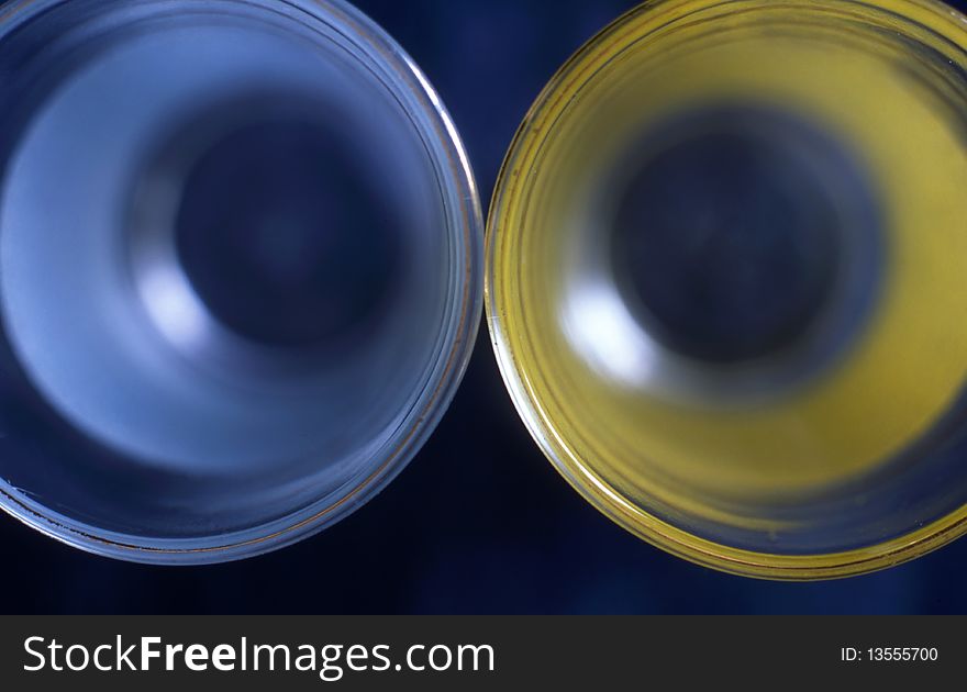Two glass isolated on dark blue background. Two glass isolated on dark blue background