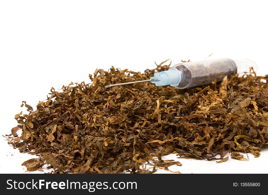 Abstract Smoking Addiction concept of pile of shredded tobacco with hypodermic needle. Abstract Smoking Addiction concept of pile of shredded tobacco with hypodermic needle.