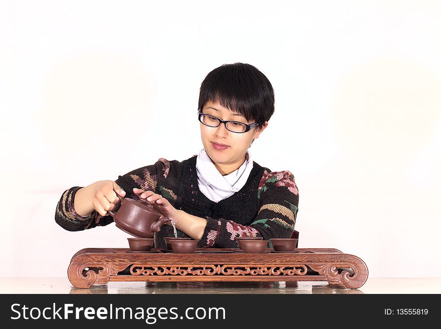 Woman pours and drinks tea