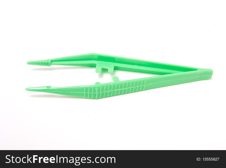 Green plastic sterile Surgical Tweezers isolated against white background.