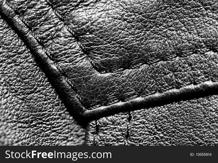 Fragment of a black leather jacket. Macro photography. Fragment of a black leather jacket. Macro photography.