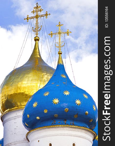 The golden and blue domes with crosses of the orthodox church. The golden and blue domes with crosses of the orthodox church