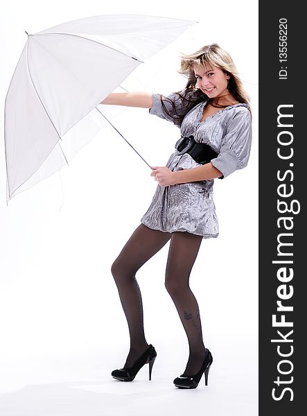 The young beautiful girl with a fair hair in a grey dress separately on a white background