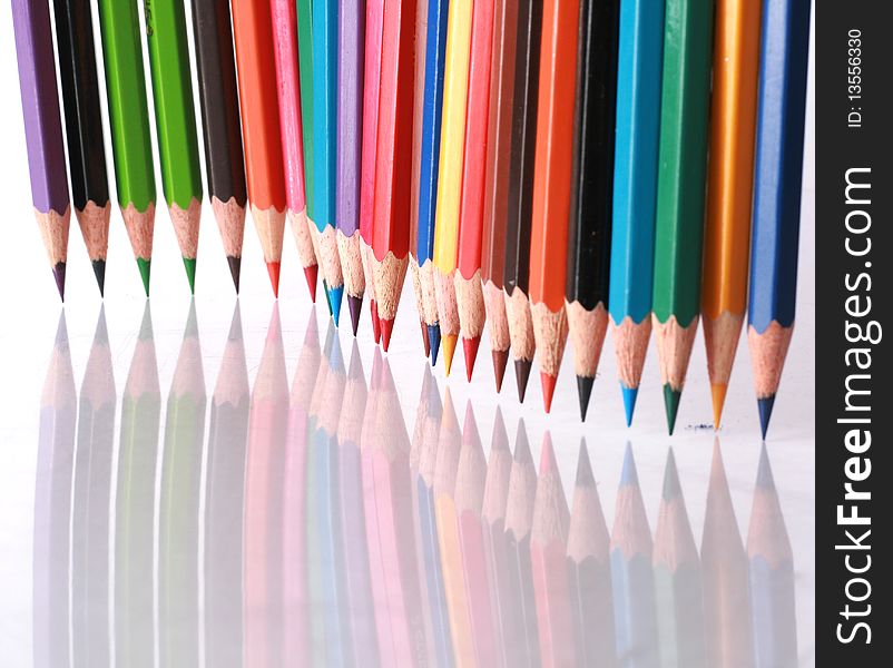 Color pencils in arrange in color wheel colors on white background