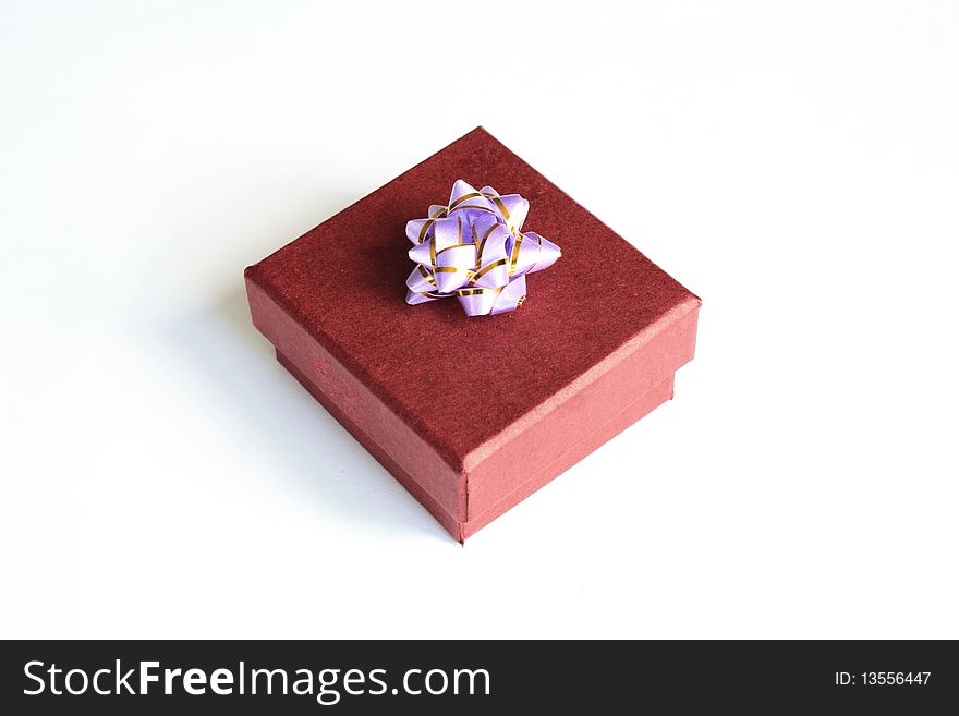 Present box with bright bow on white background