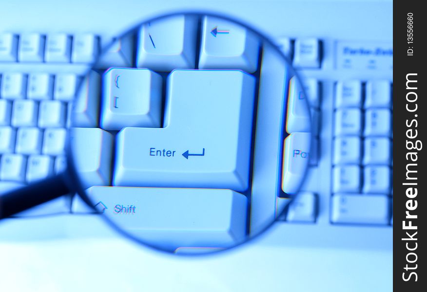 Magnifying glass on keyboard white