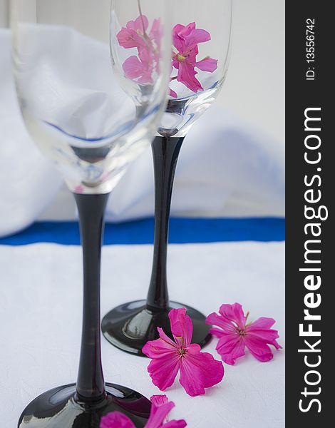 Two empty wine glasses costing on a white cloth