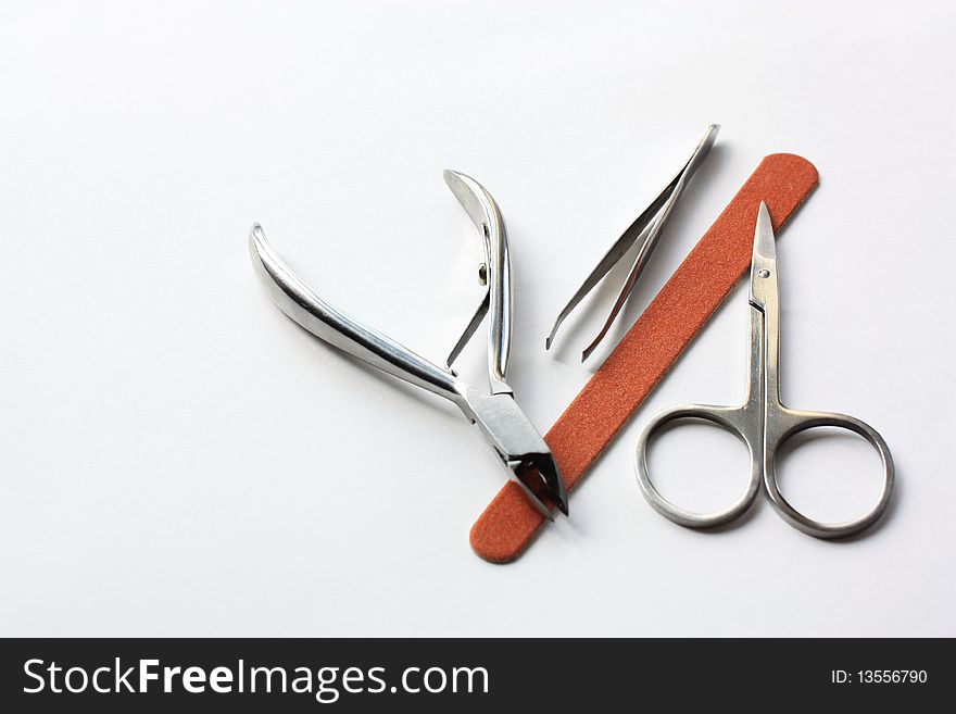 Steel tools for manicure on white background