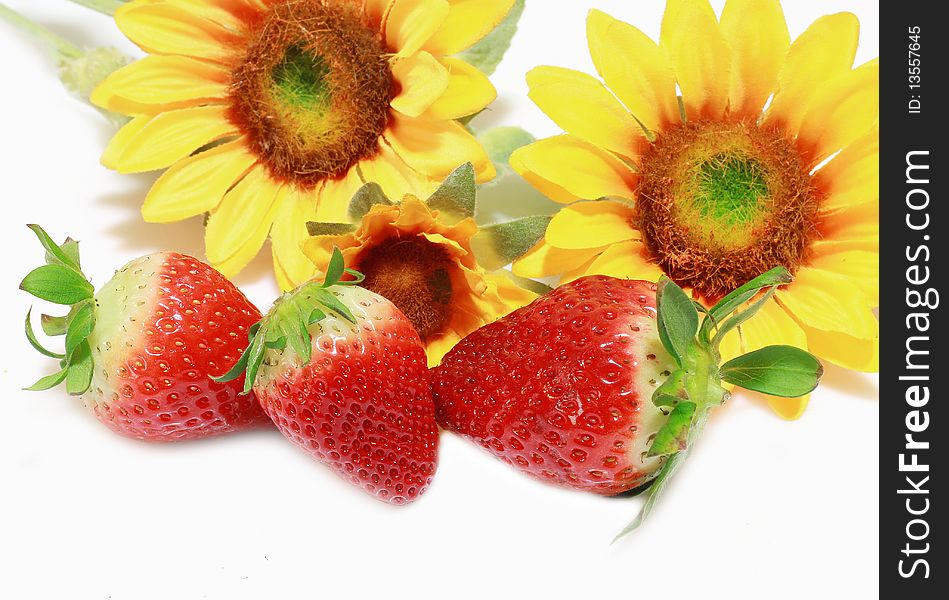 Fresh strawberries with sunflowers isolated on white background