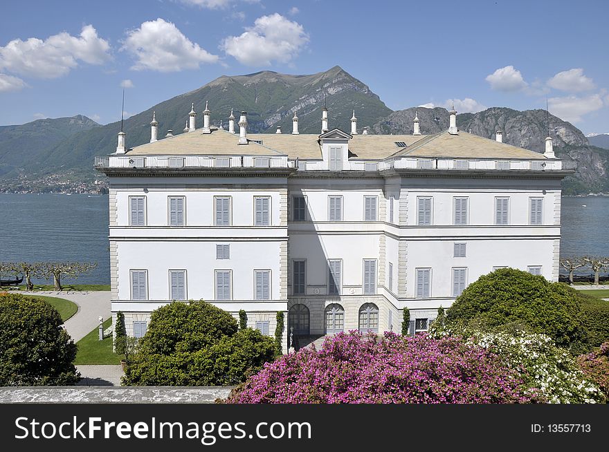 Magnificent Villa Melzi on the shores of Lake Como with mountains in the distance. Magnificent Villa Melzi on the shores of Lake Como with mountains in the distance