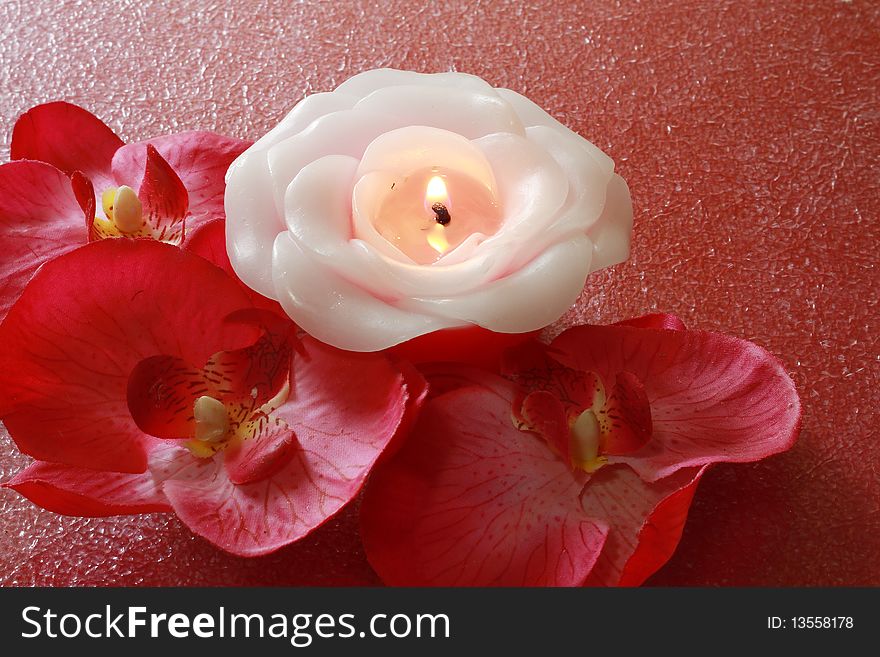 A spa items composition with flowers and candle.