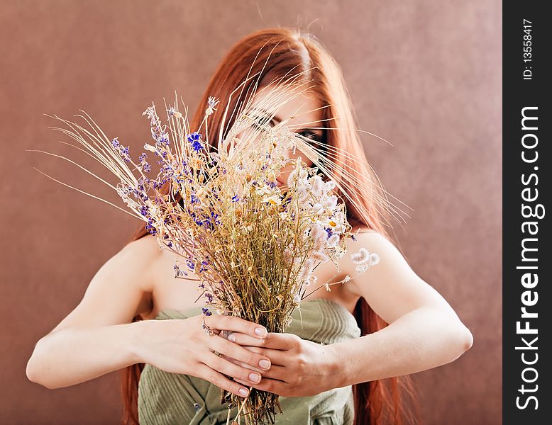 Girl with red hair holding flowers bouquet. Girl with red hair holding flowers bouquet