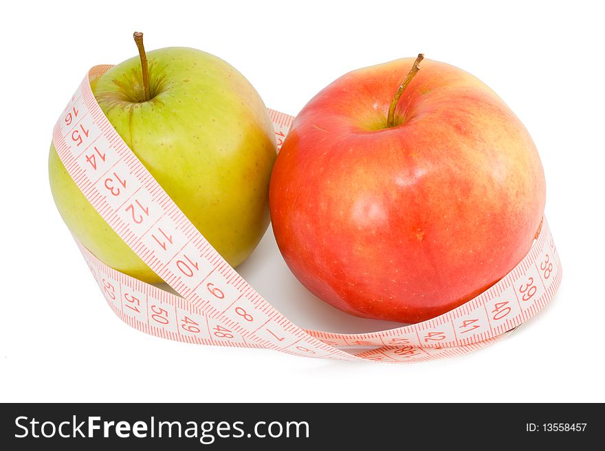 The untwisted measuring tape and two apples on a white background. The untwisted measuring tape and two apples on a white background