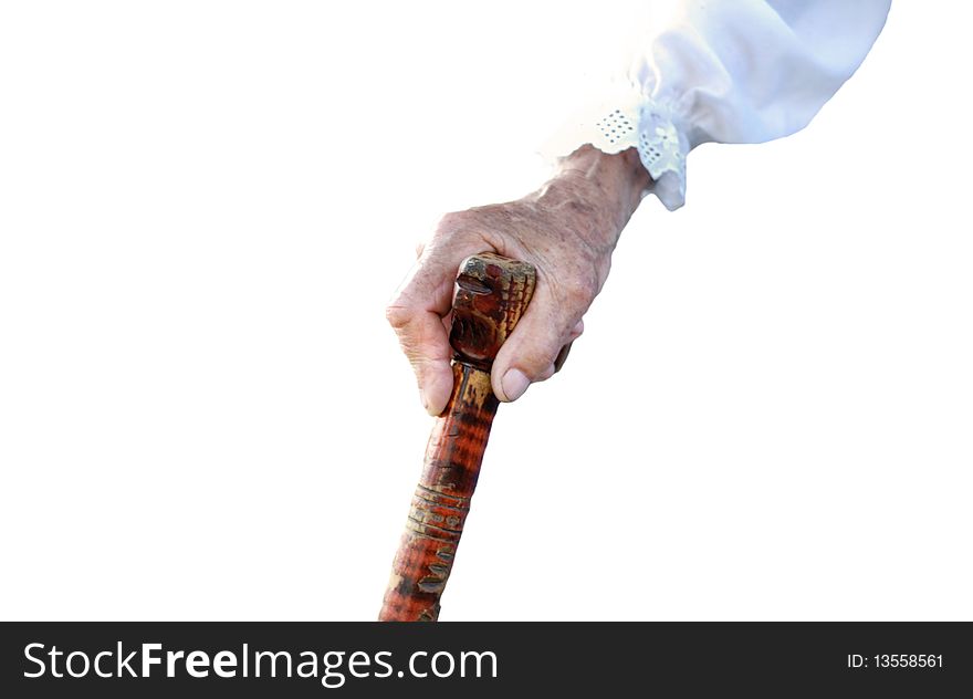 Hand of an old peasant woman holding a walking stick isolated on white background