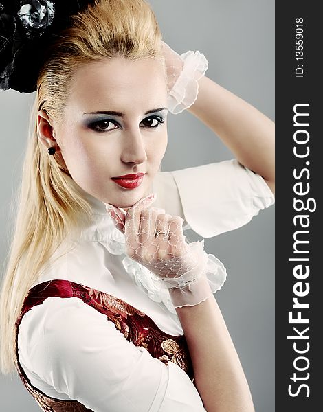 Portrait of the elegant young woman in 19th century costume. Shot in a studio. Portrait of the elegant young woman in 19th century costume. Shot in a studio.