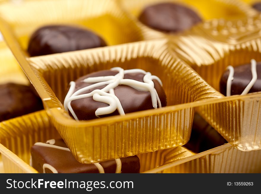 A horizontal image of two trays of chocolates