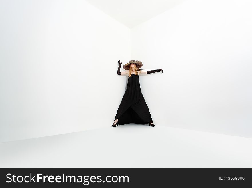 Portrait of a beautiful girl in elegant black dress and a  hat. Isolated over white background. Portrait of a beautiful girl in elegant black dress and a  hat. Isolated over white background.