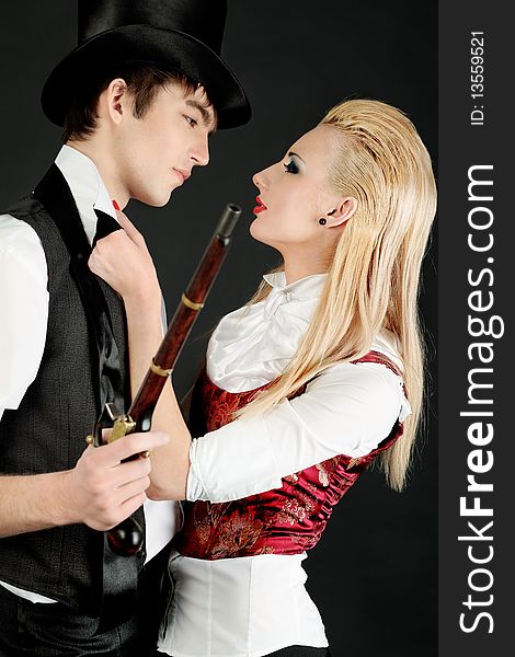 Portrait of the elegant young couple in 18, 19th century costumes. Shot in a studio. Portrait of the elegant young couple in 18, 19th century costumes. Shot in a studio.