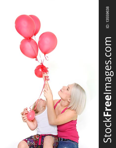 Mother and daughter with red balloons over white