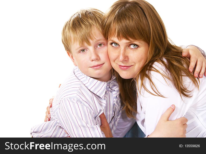 Tween boy hugging her mother over white