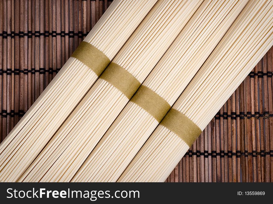 Bunches of uncooked oriental noodles on a rural mat. Bunches of uncooked oriental noodles on a rural mat.