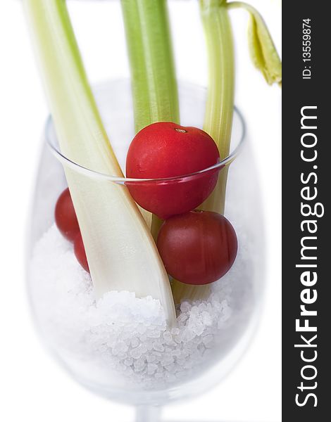 A stylish glass of celery and tomato with salt. A stylish glass of celery and tomato with salt
