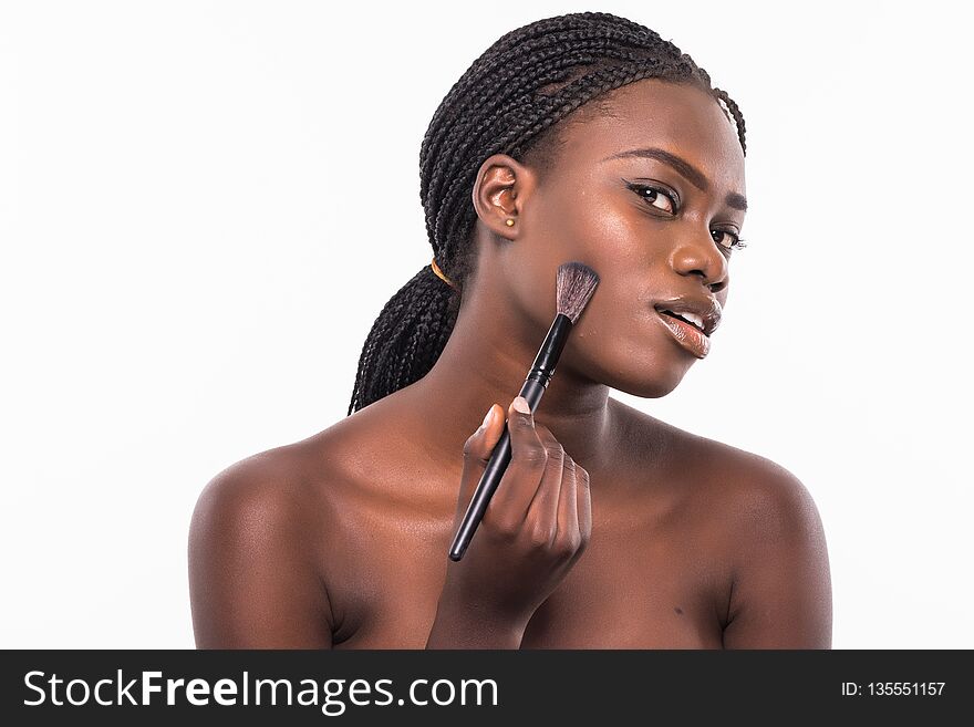 Beauty Portrait Of A Smiling Beautiful Half Naked African Woman Applying Make-up With A Brush And Looking At Camera Isolated Over