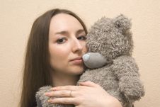 Girl Embraces A Bear Stock Images