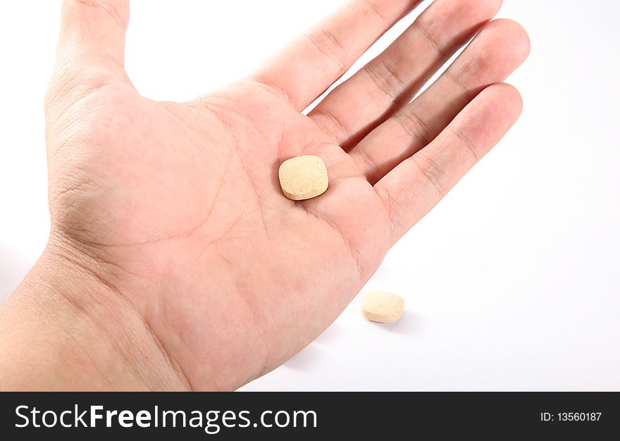 Hand Take pill over white background