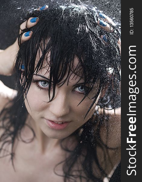 Portrait of the smiling brunette in drop of water on black background. Portrait of the smiling brunette in drop of water on black background