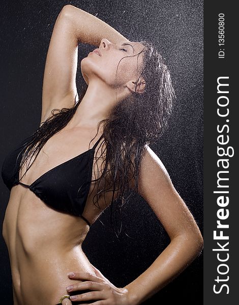 A young attractive woman is covered with dripping water. A young attractive woman is covered with dripping water.