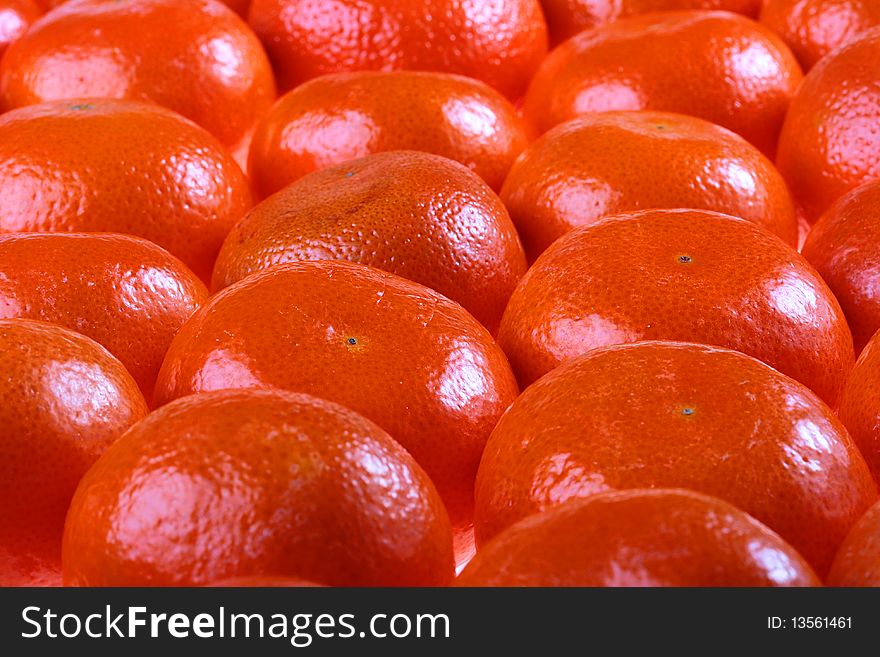 Tangerines are combined abreast and make a background.