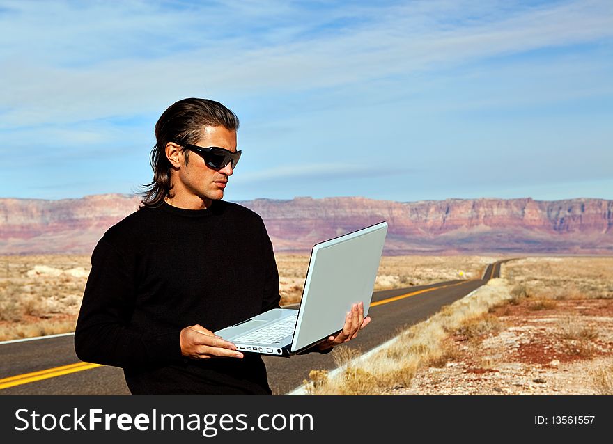 Man On Road With Laptop