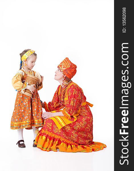 Woman and girl in Russian handmade traditional clothing on isolated background. Woman and girl in Russian handmade traditional clothing on isolated background