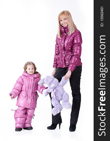 Young attractive blonde woman and little girl in fashinable clothing on isolated background. Young attractive blonde woman and little girl in fashinable clothing on isolated background