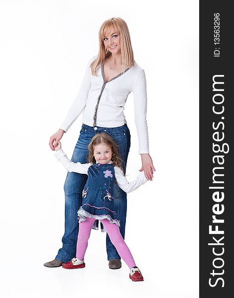 Young attractive blonde woman and little girl in fashinable clothing on isolated background. Young attractive blonde woman and little girl in fashinable clothing on isolated background