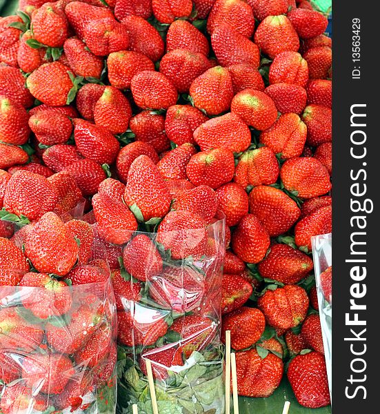 The juicy fresh strawberry is on sale on a tray