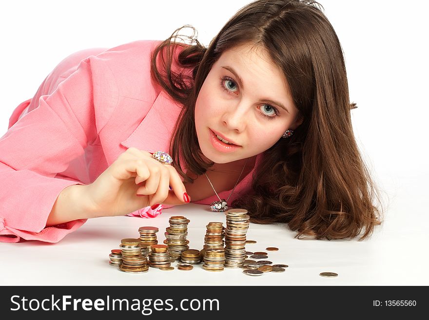 A young woman touching stacks of coins
