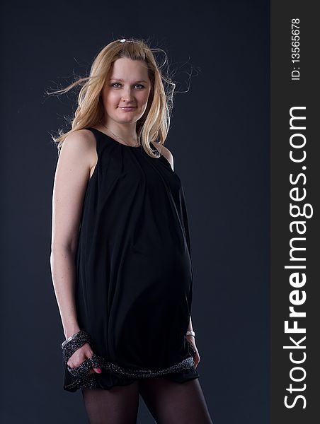 Blondy woman expecting a baby/black background. Blondy woman expecting a baby/black background