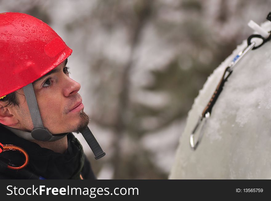 An ice climber ascending cliff face