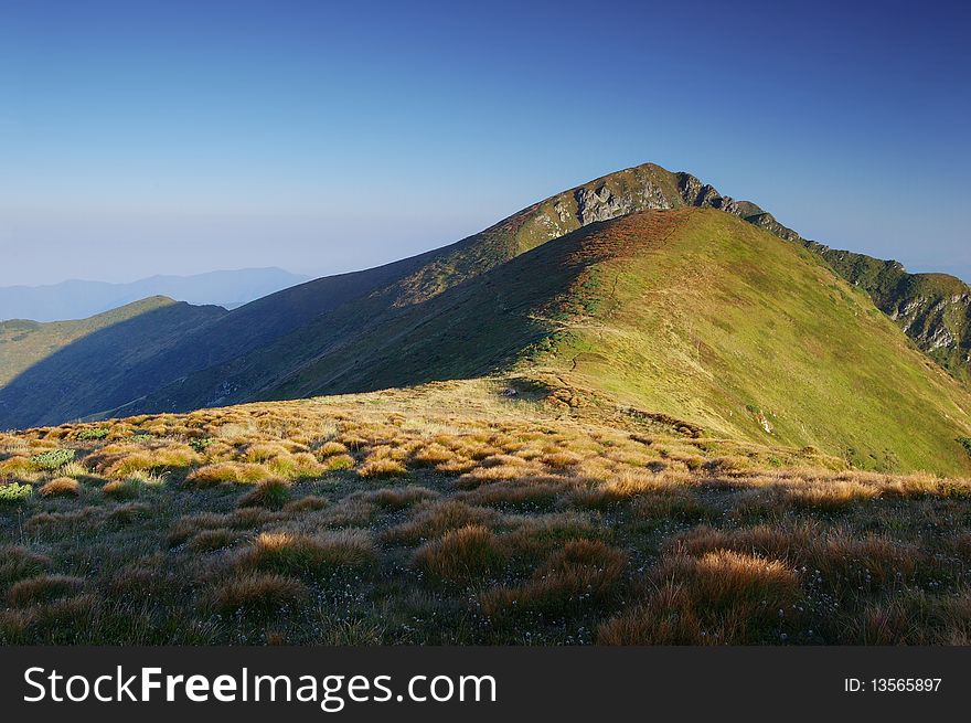 Morning in the mountains, the first beams of a rising sun shine mountains. Ukraine, Carpathians. Morning in the mountains, the first beams of a rising sun shine mountains. Ukraine, Carpathians