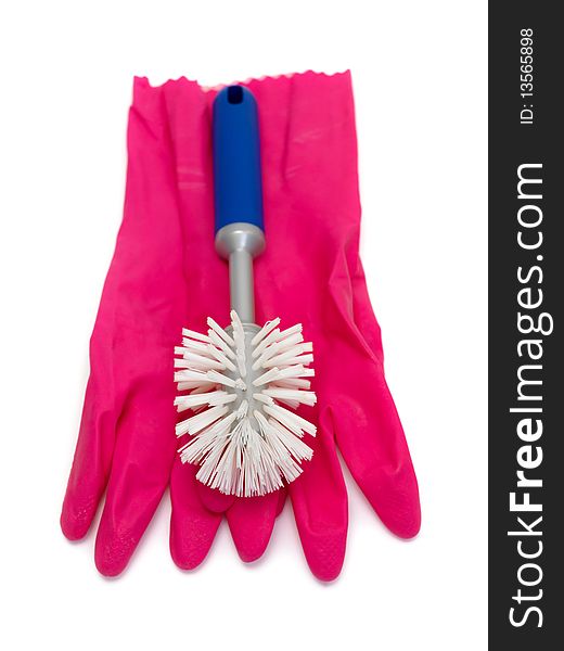 A scrubbing brush and rubber gloves  isolated against a white background. A scrubbing brush and rubber gloves  isolated against a white background