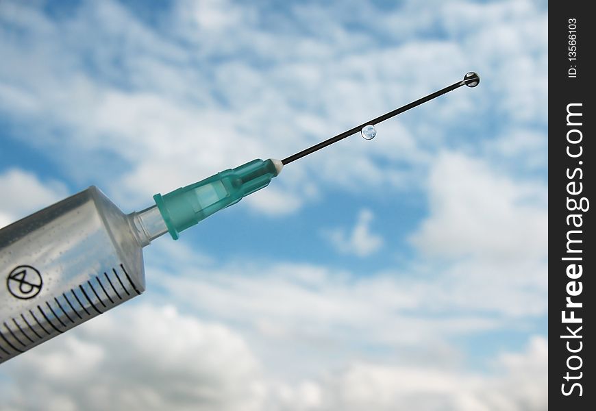 Disposable syringe against the blue sky