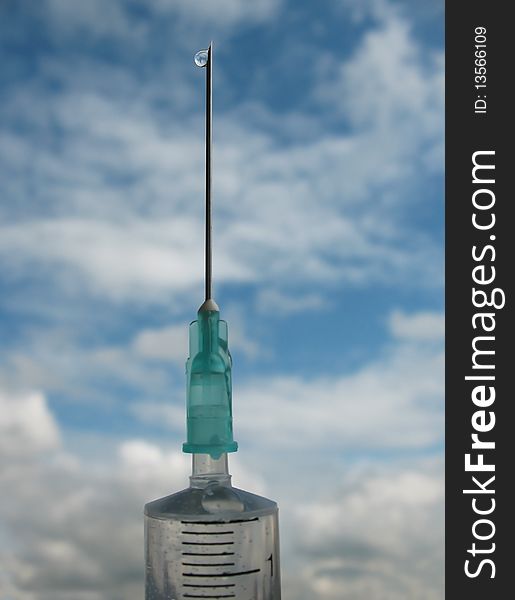 Disposable syringe against the blue sky