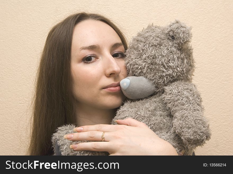 Young girl embraces a teddy bear. Young girl embraces a teddy bear