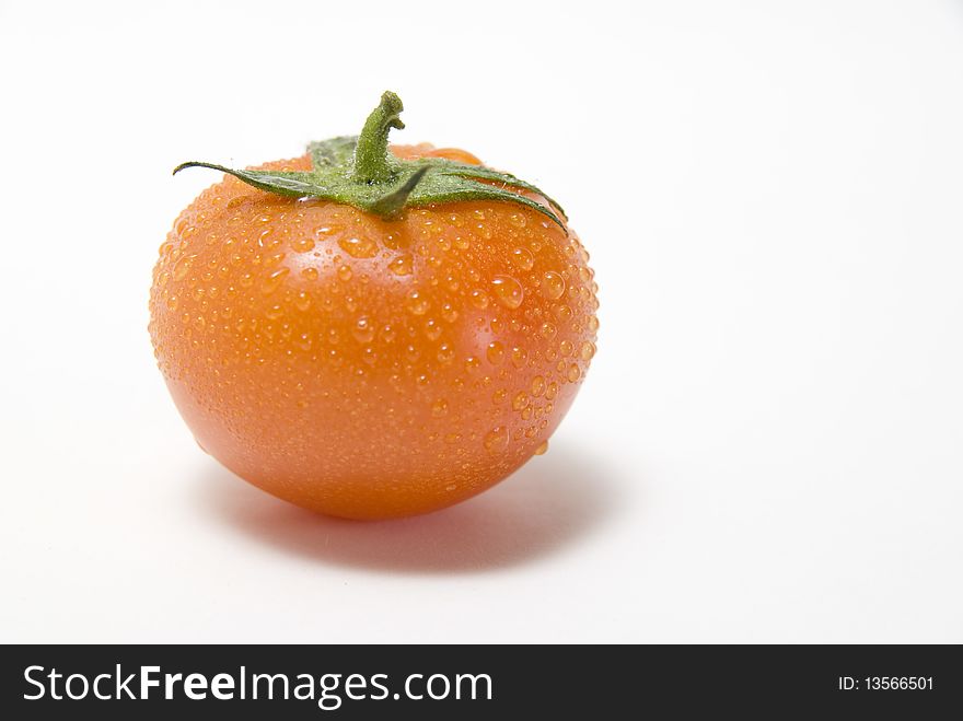 The fresh tomato on the white background