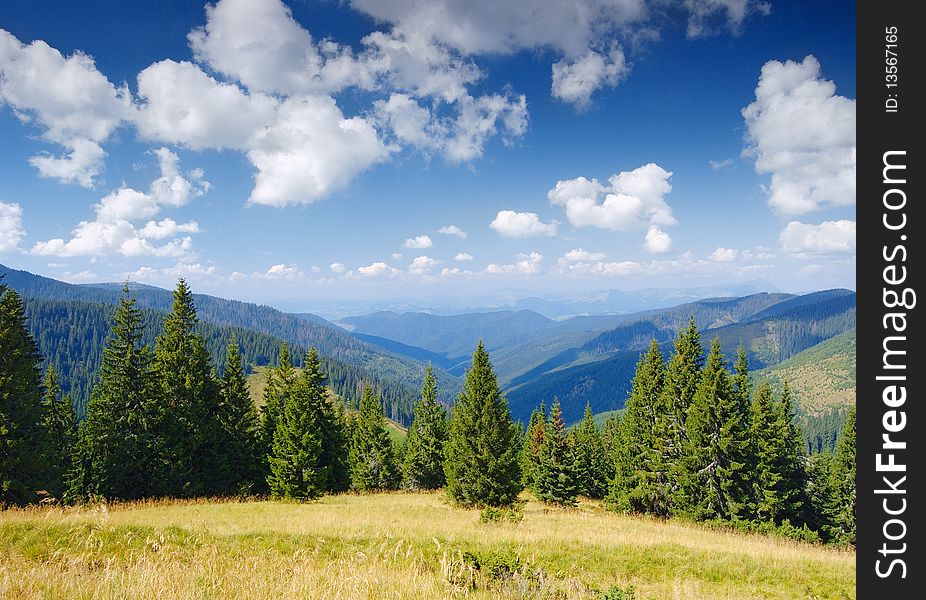 Landscape of summer mountains with the blue sky and clouds. The Ukrainian Carpathians. Landscape of summer mountains with the blue sky and clouds. The Ukrainian Carpathians