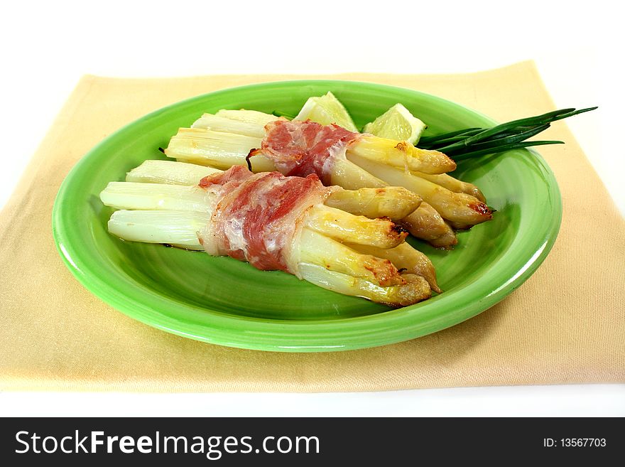White asparagus with ham baked in the oven. White asparagus with ham baked in the oven