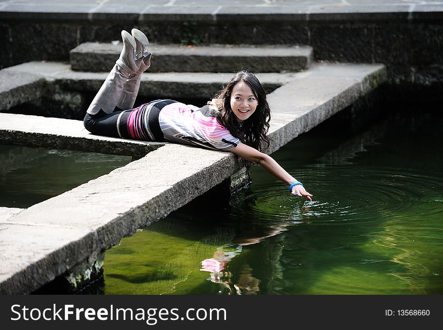 Chinese girl playing by water. Chinese girl playing by water.